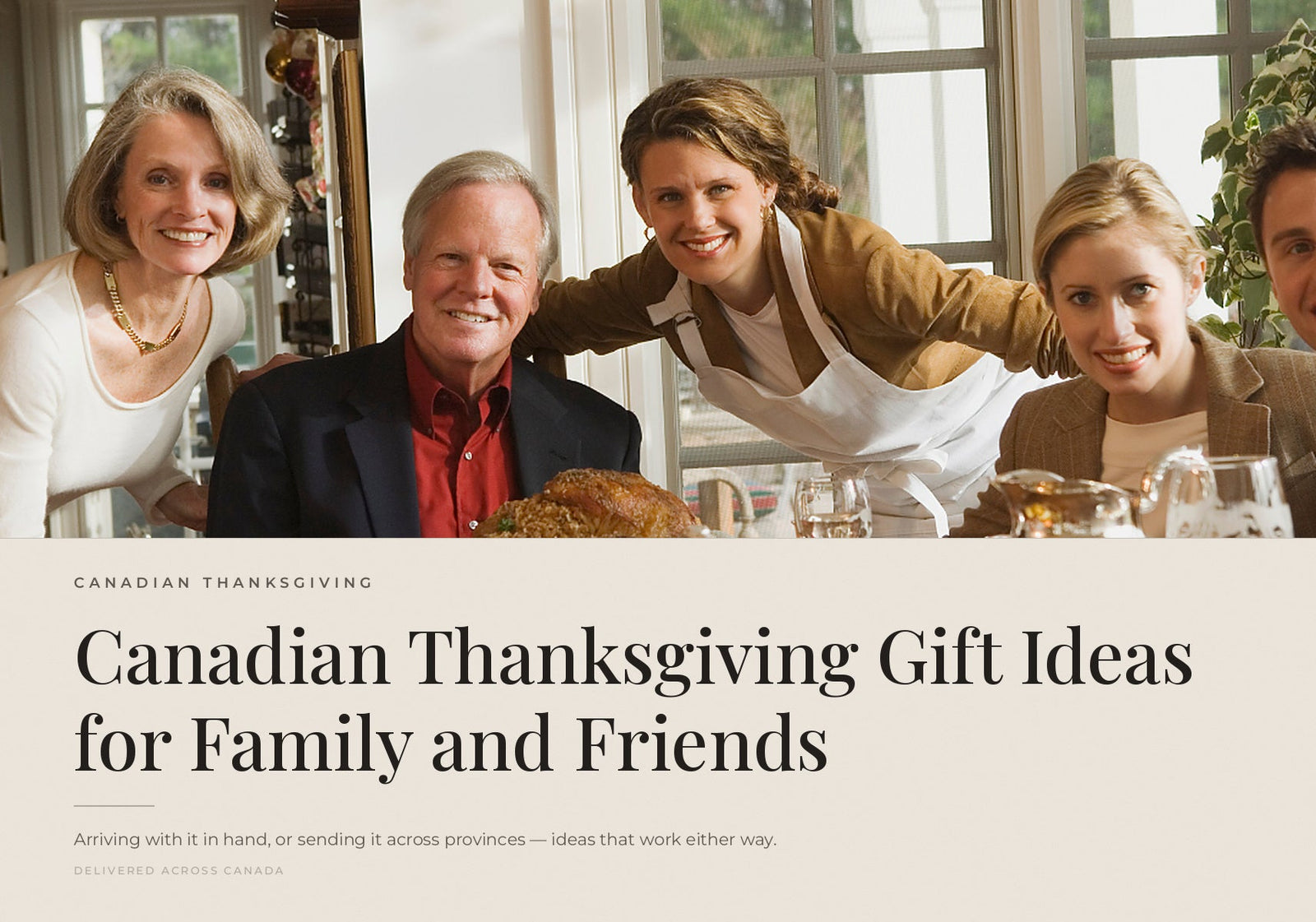 A smiling family gathered together around a table celebrating Thanksgiving.