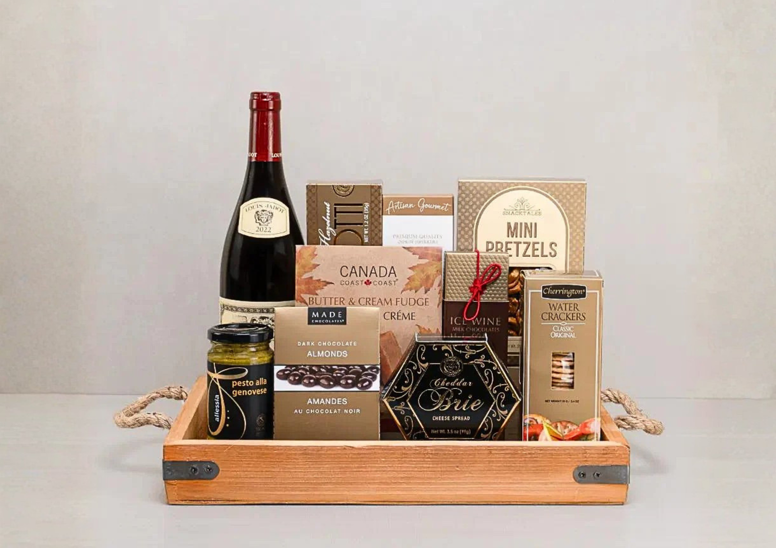 Same-day Toronto gift basket delivery featuring premium wine, artisan snacks, and chocolates in a wooden tray.