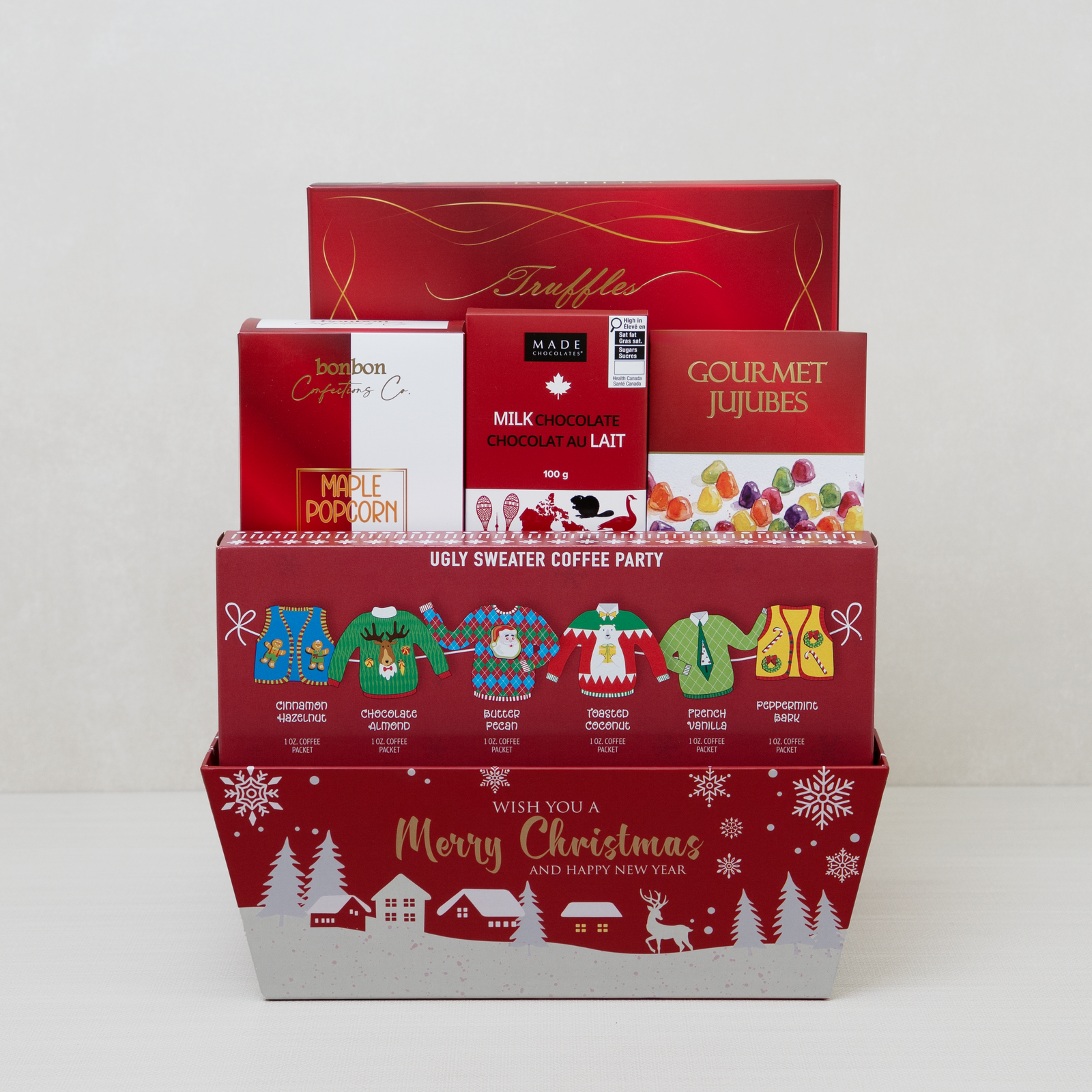 Christmas Goodies Gift Basket: six Ugly Sweater flavoured coffees, cocoa truffles, maple popcorn and jujubes in red packaging