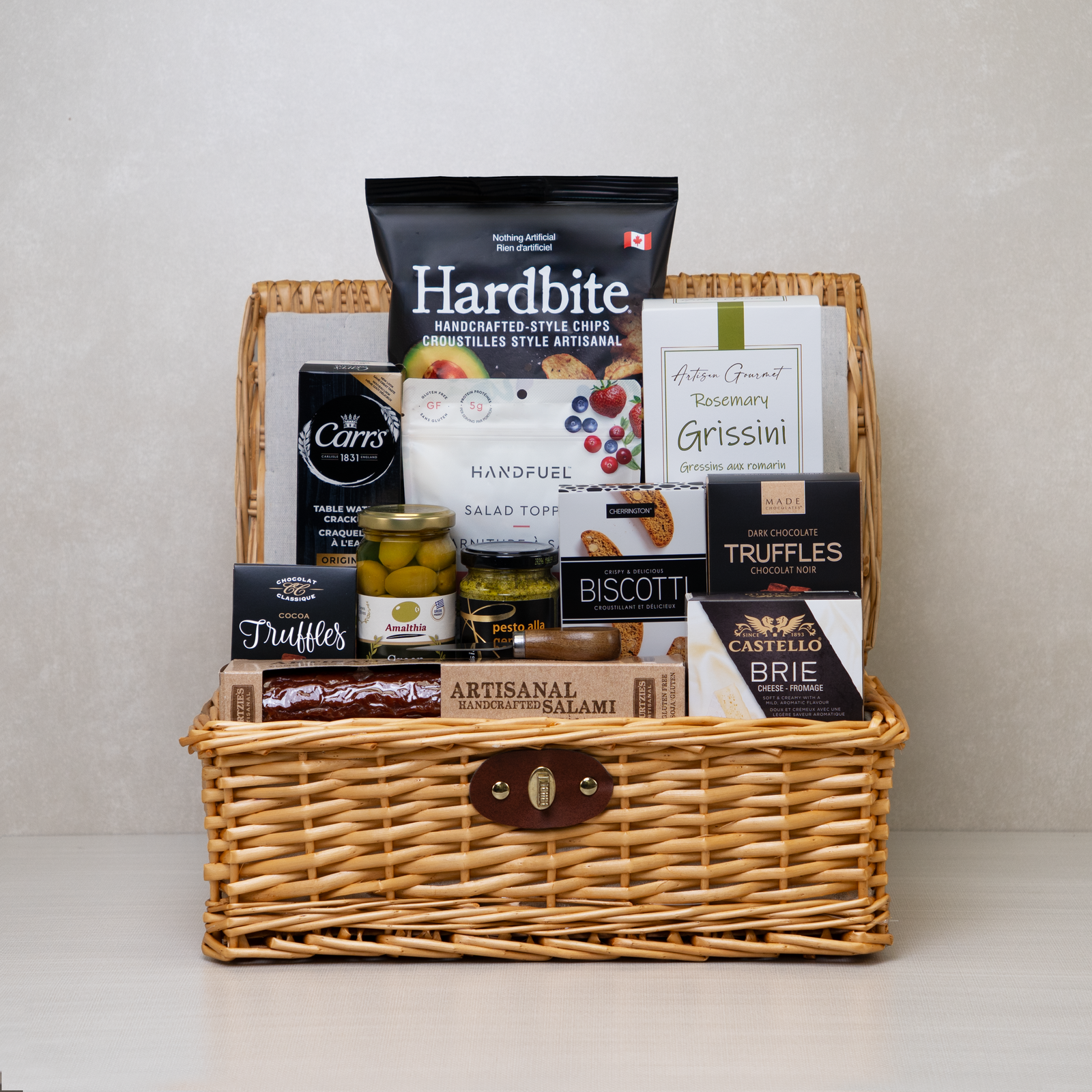 Gourmet Family Gathering Basket, a lidded wicker hamper with salami, Castello brie, Hardbite chips, grissini and truffles