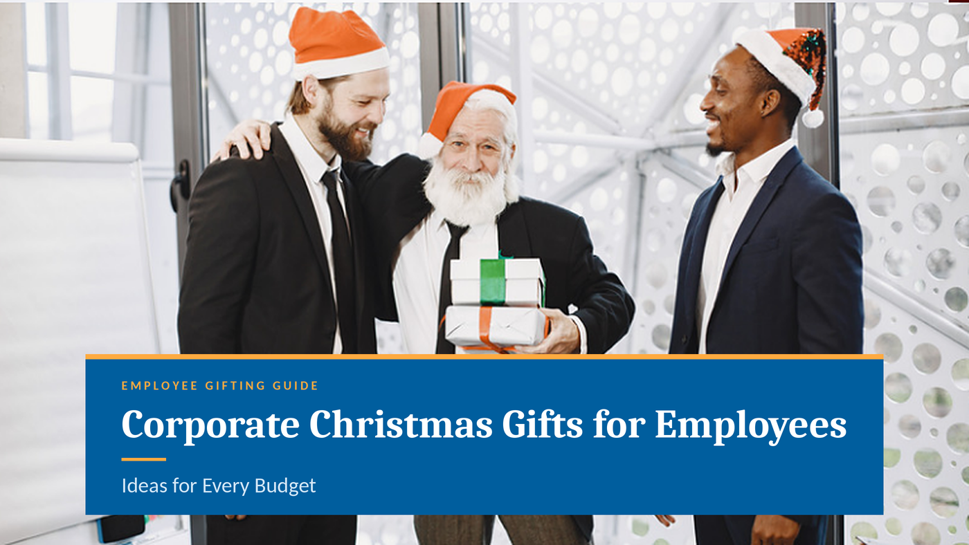 Diverse corporate team wearing Santa hats celebrating Christmas and exchanging wrapped holiday gifts in the office.