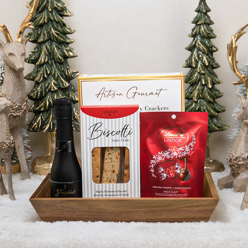 Sparkling Holiday Basket with mini Freixenet bubbly, maple biscotti, Lindt Lindor truffles and rosemary crackers on a tray