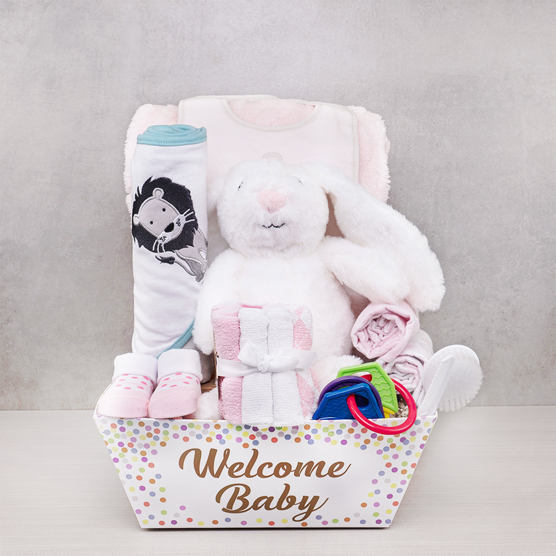 A baby gift set with a plush bunny, keepsakes and treats for a new arrival
