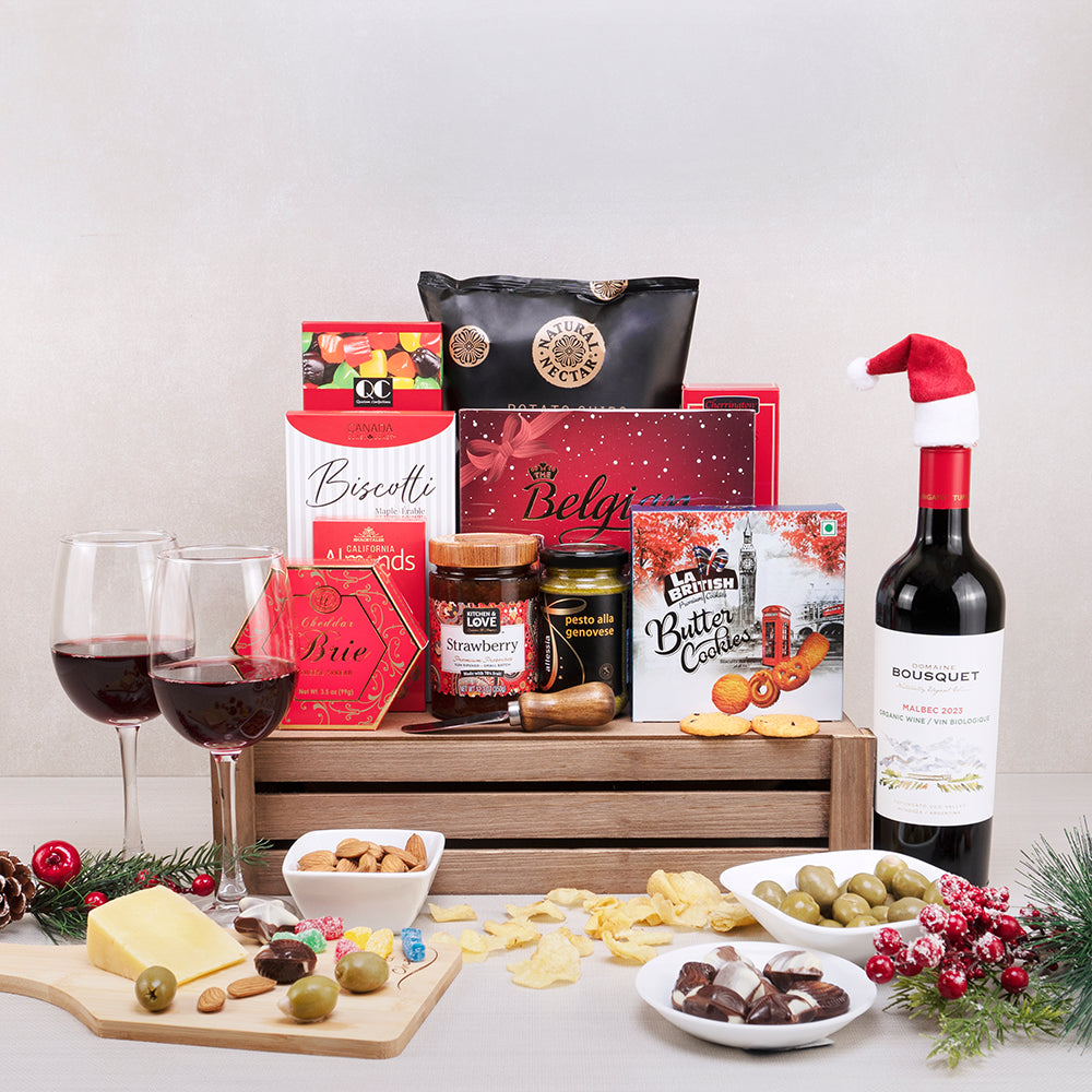 Festive Feast Wine & Treats Basket with Malbec in a Santa hat, Belgian chocolates, butter cookies and jam in a wooden crate
