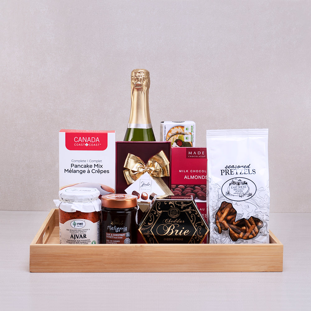Rise & Shine Champagne Basket with sparkling wine, pancake mix, Meligyris honey, Hamlet chocolates and pretzels on a tray