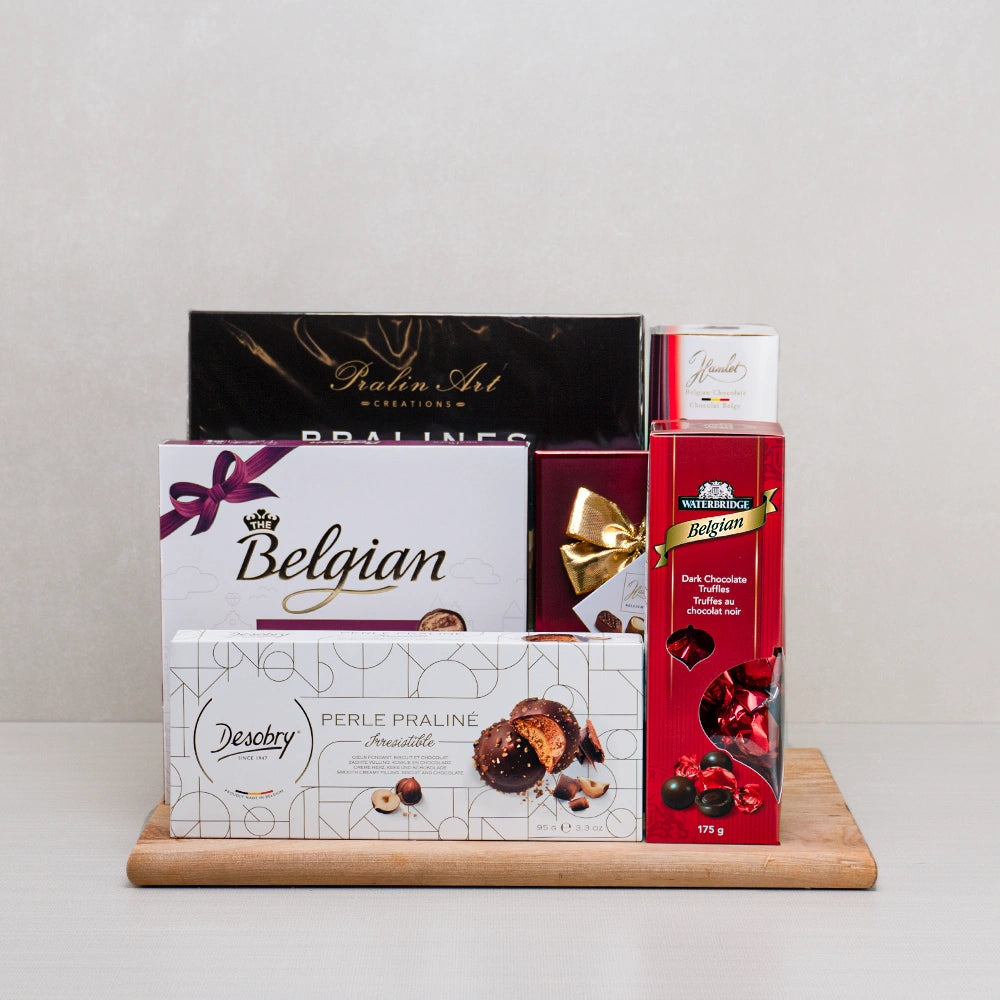 The Chocolate Symphony gift set with Desobry praline cookies, Waterbridge truffles and Belgian pralines on a wooden board