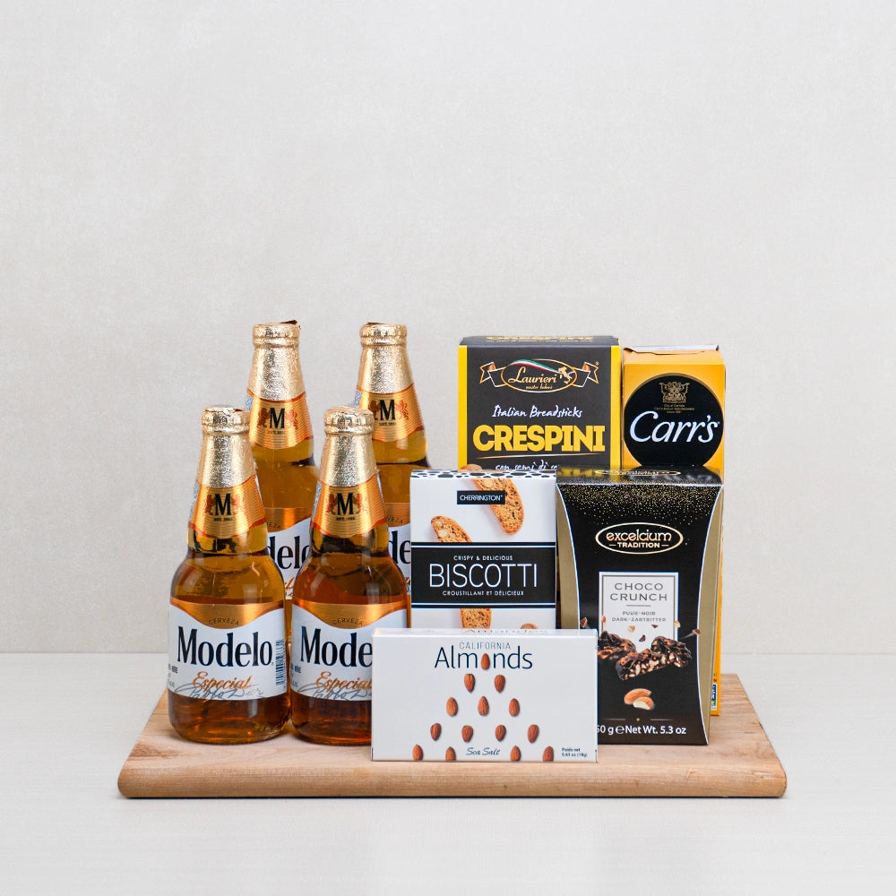 Modelo Moments Gift Basket with four Modelo Especial beers, Crespini breadsticks, Choco Crunch and almonds on a wood board