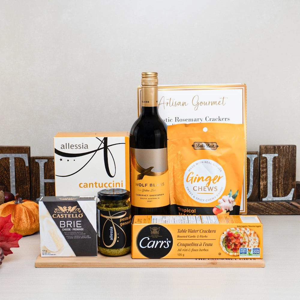 Family Feast Gourmet Hamper with Wolf Blass Cabernet Sauvignon, Castello brie, cantuccini and ginger chews on a bamboo board