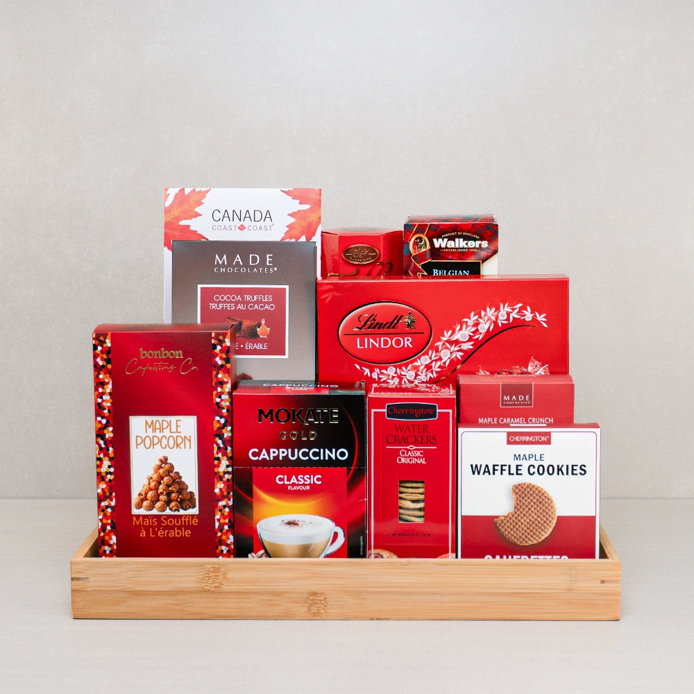 Family Feast Holiday Basket with Lindt Lindor, maple popcorn, Mokate cappuccino and Walkers biscuits in a bamboo tray