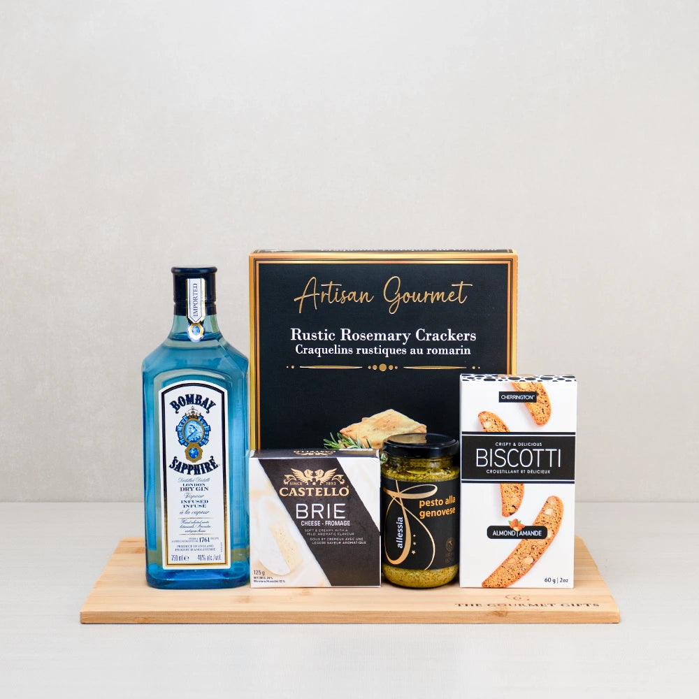Gin Lover’s Gourmet Gift Basket with Bombay Sapphire gin, Castello brie, rosemary crackers, biscotti and pesto on a board