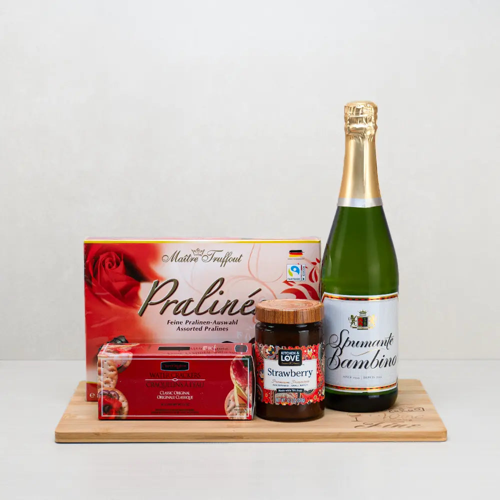 Be My Valentine Gift Basket with Spumante Bambino sparkling wine, Maître Truffout pralines and strawberry preserve on a board