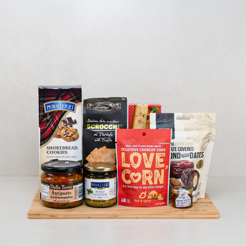 Cupid’s Snack Cravings Basket with chocolate-covered stuffed dates, Love Corn, Scrocchi truffle crackers, antipasto and pesto