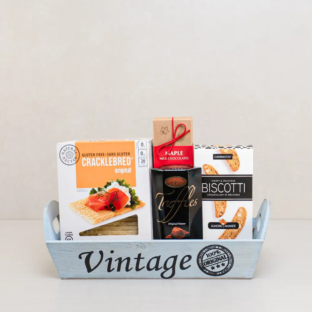Tastes of Joy gift basket with Cracklebred, Belgian truffles, maple chocolates and almond biscotti in a pale blue wood tray