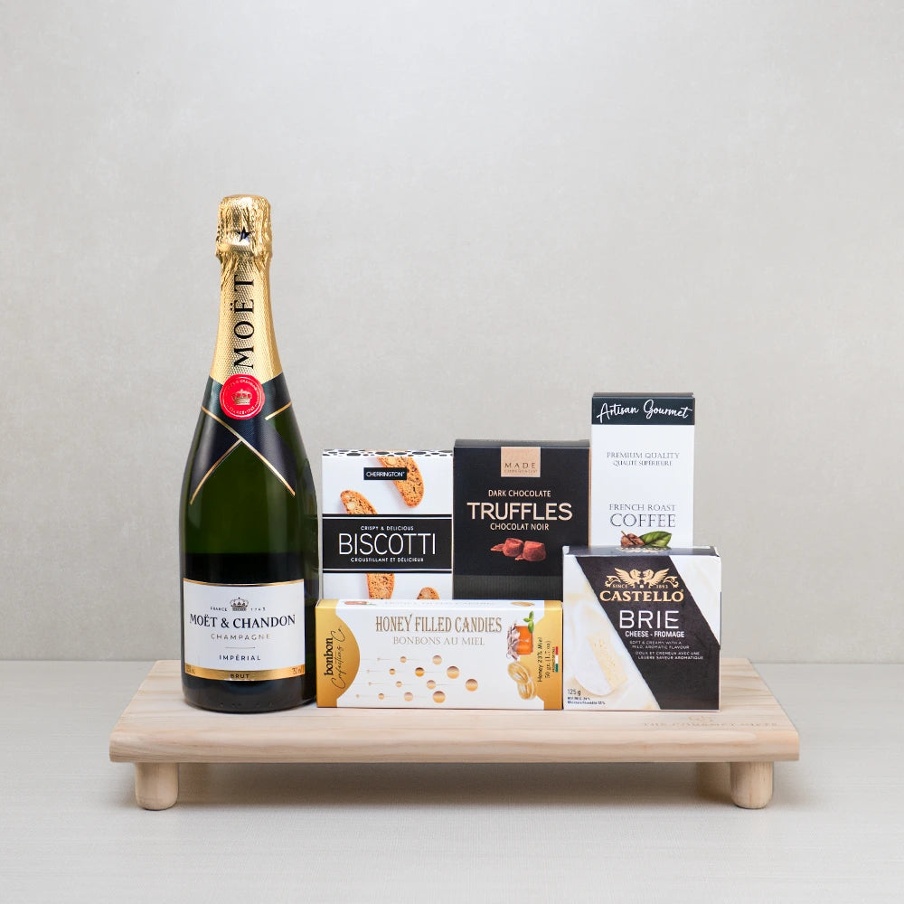 Moët & Truffles Celebration Basket with Moët Impérial, Castello brie, dark truffles and honey candies on a footed board