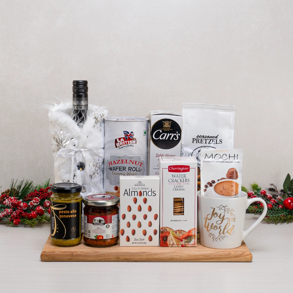 The Joyful Snacker’s Basket with wine in a faux fur cover, a Joy to the World mug, hazelnut wafer rolls, pesto and pretzels