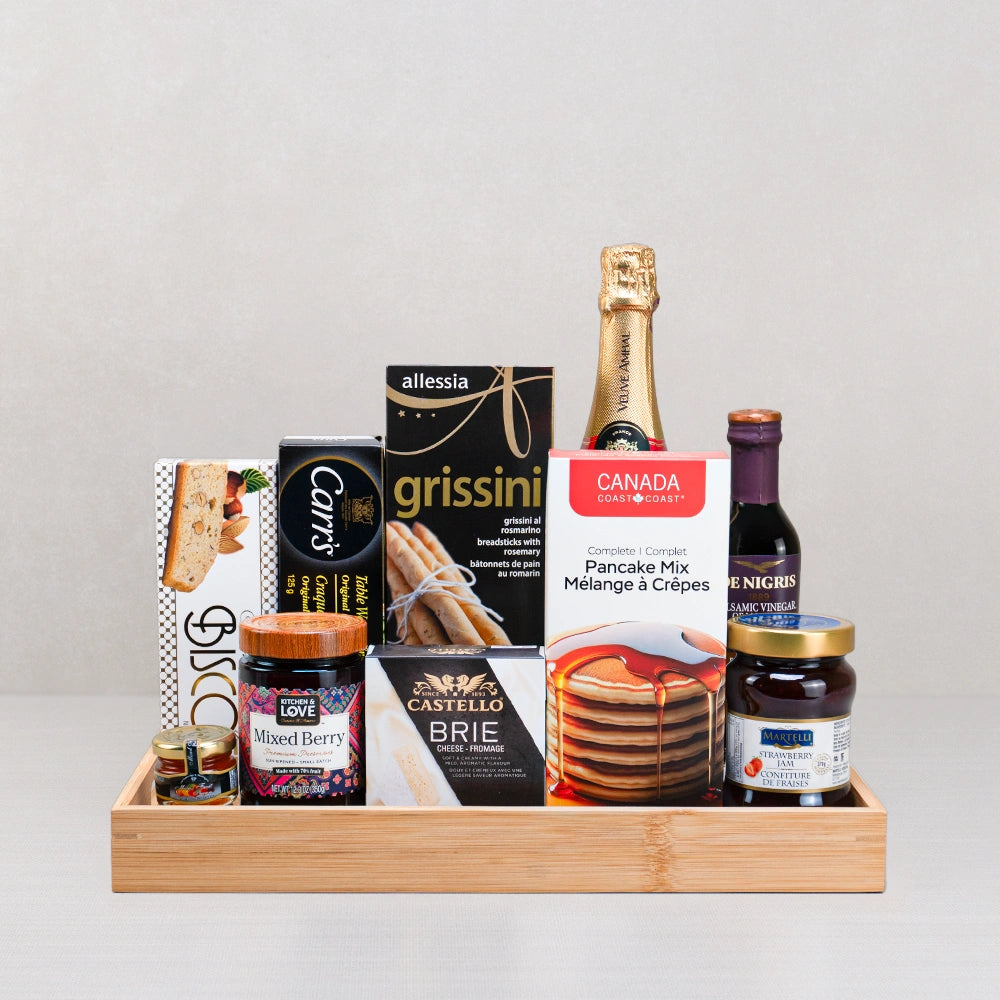 The Ultimate Countryside Pancake Experience gift set: pancake mix, mini sparkling wine, Castello brie and jams on bamboo