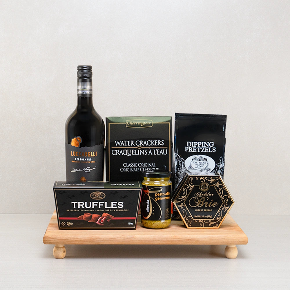 Raspberry Truffle & Brie Luxury Box with Luccarelli Negroamaro, raspberry truffles, brie spread and pesto on a footed board