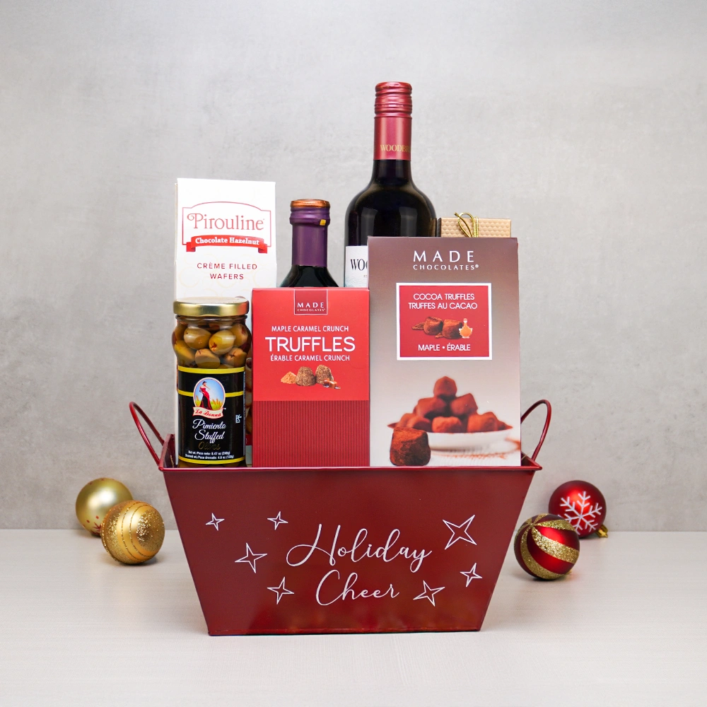 The Ultimate Christmas Cheer Basket with red wine, maple truffles, Pirouline wafers and olives in a red Holiday Cheer tin