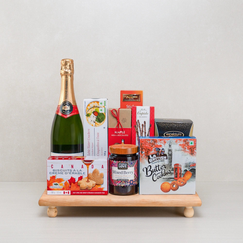 True North Artisan Basket with sparkling wine, maple cream cookies, berry preserve and La British butter cookies on a tray