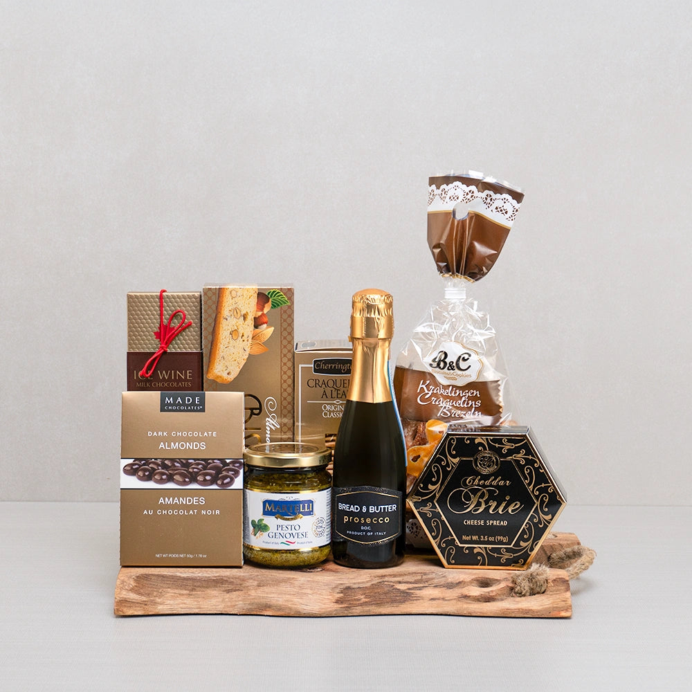 La Dolce Vita Gift Basket with mini Prosecco, Icewine chocolates, Martelli pesto and puff pastry twists on a live edge board