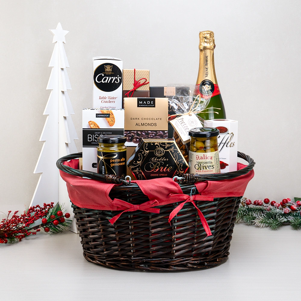 Merry & Bright Celebration Basket with Veuve Ambal sparkling wine, chocolate almonds, olives and pesto in red-lined wicker