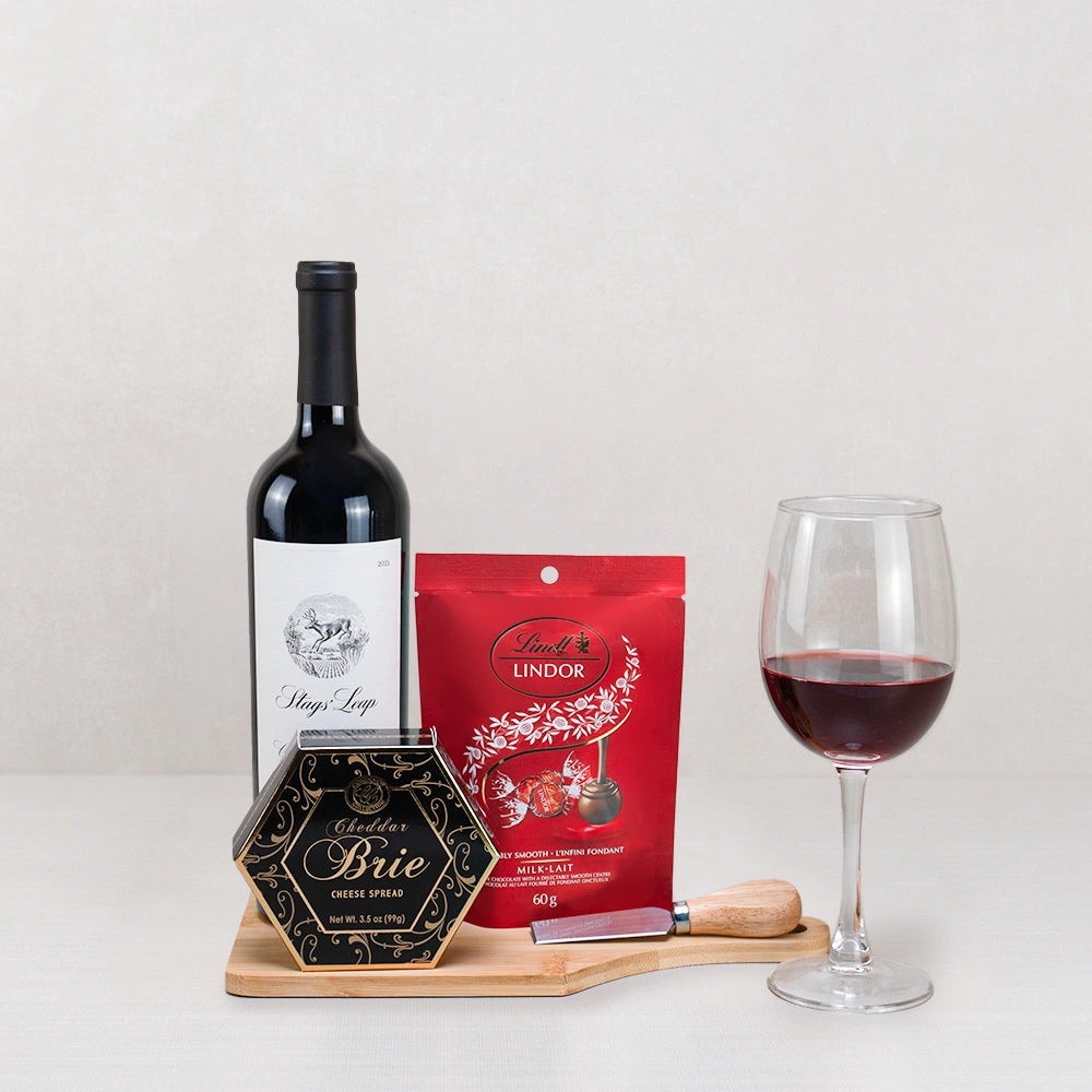 The Legacy Wine & Artisan Gourmet gift set with Stags' Leap red wine, Lindt Lindor, Cheddar Brie spread and a cheese knife