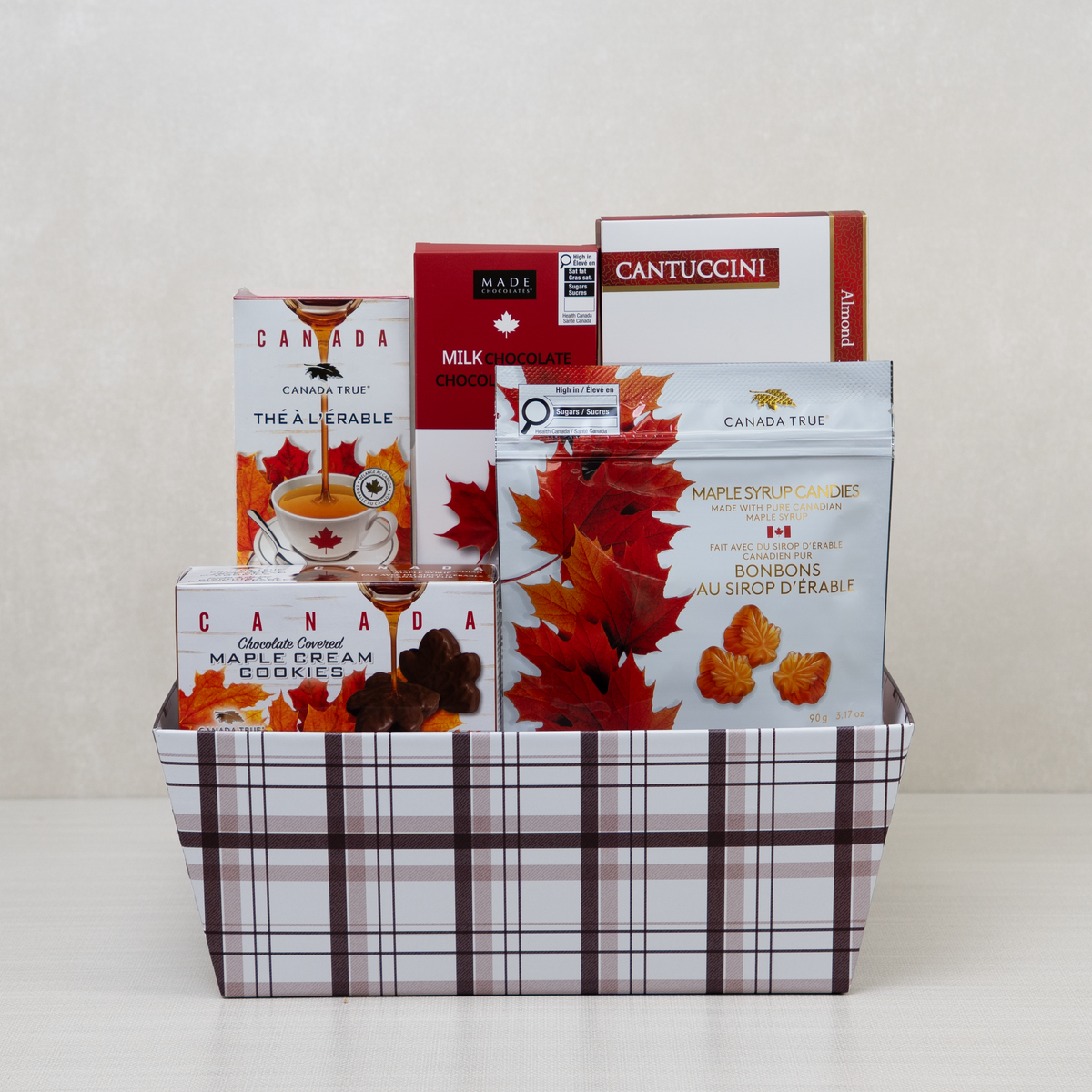 Sweet Maple Retreat Basket in brown plaid with Canada True maple tea and candies, maple cream cookies and almond cantuccini