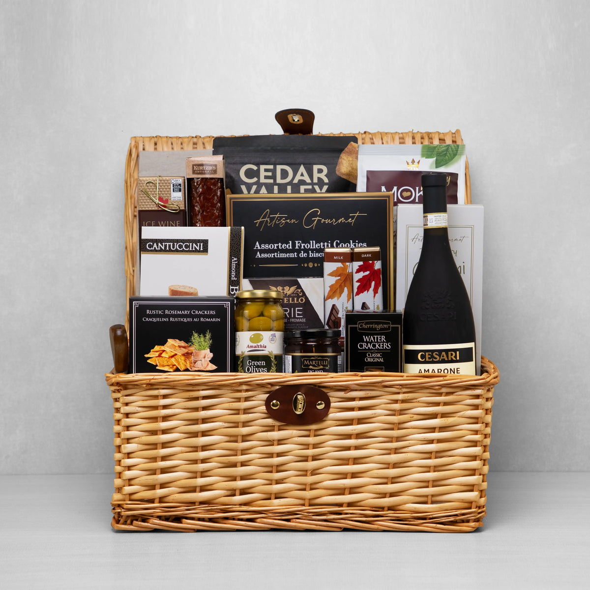 Grand Gourmet Gift Basket with red wine, chocolates, brie, and savoury snacks.