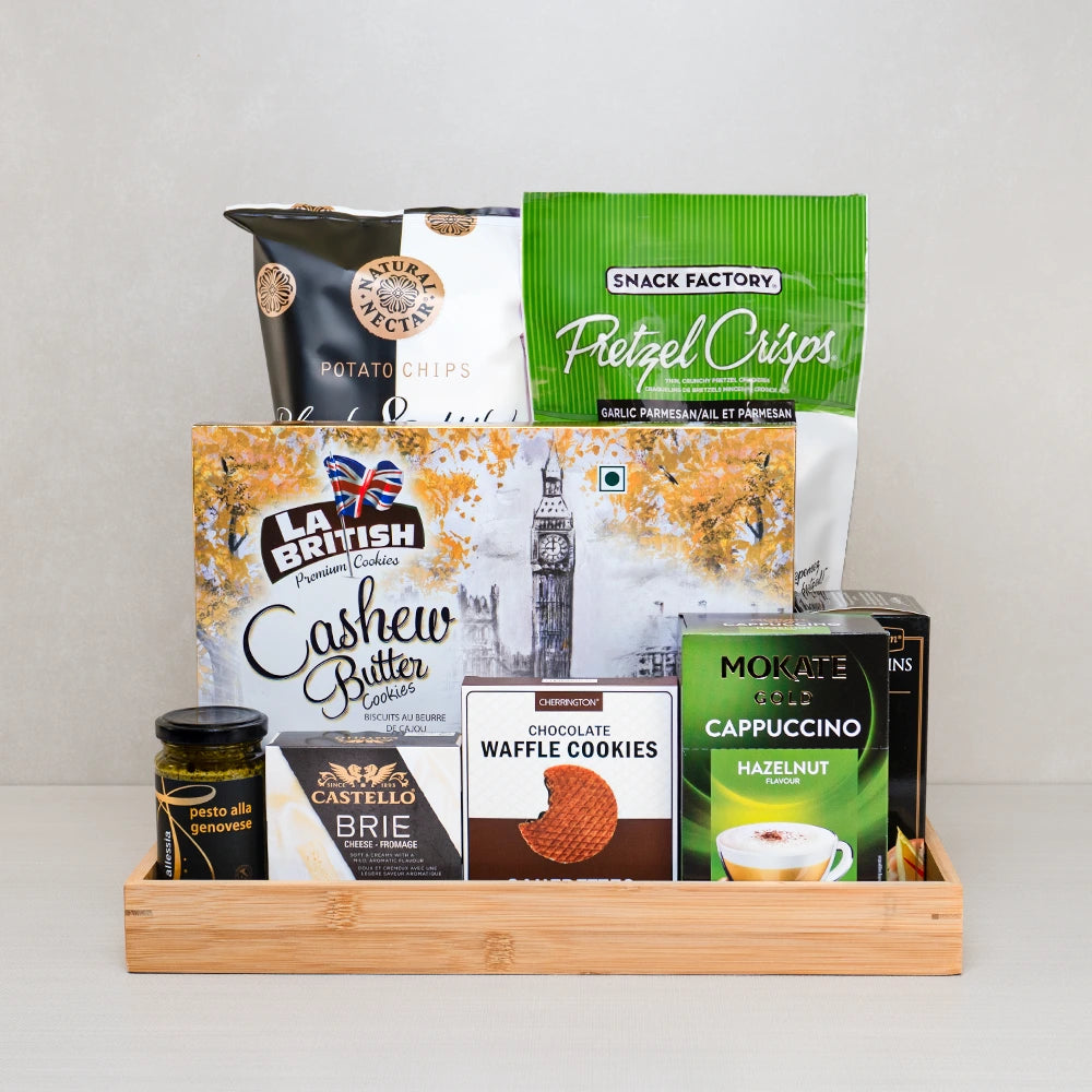 Together at the Table Basket with Castello brie, La British cashew butter cookies, Pretzel Crisps and pesto on a bamboo tray