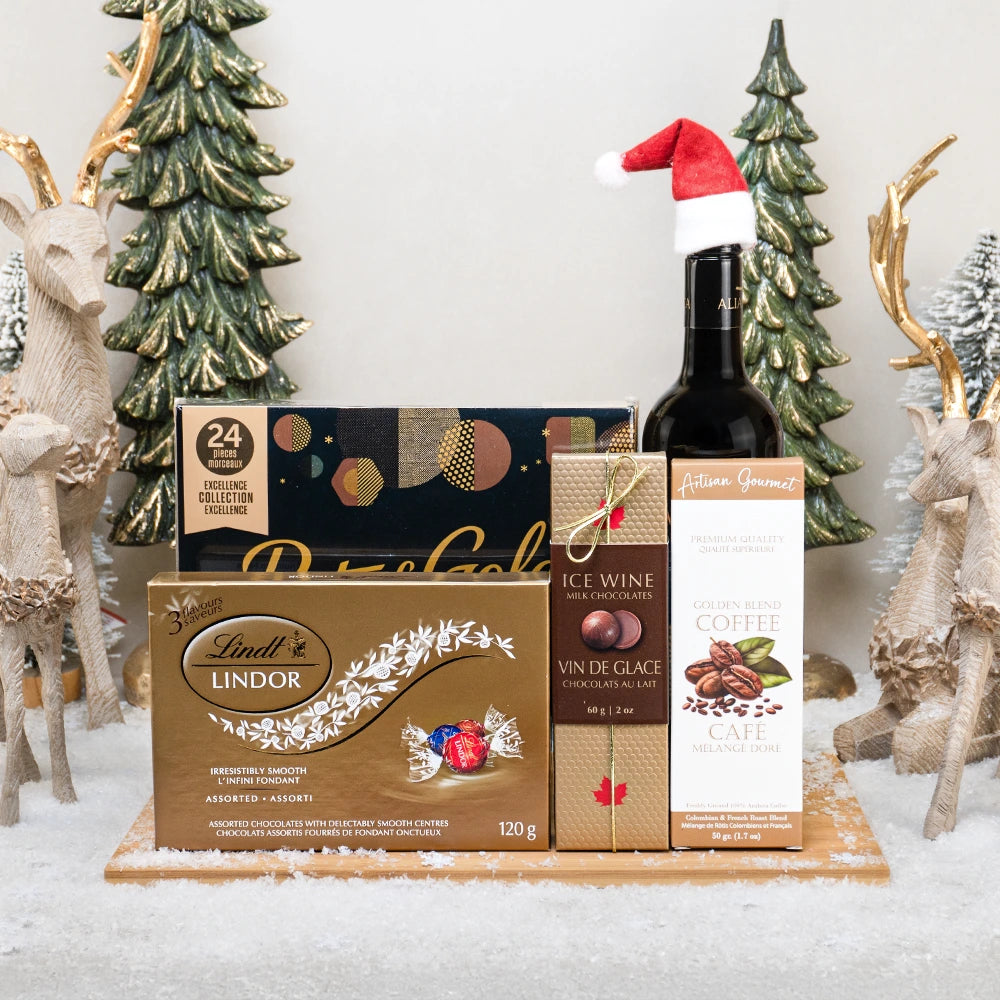 Twinkling Treats Basket with red wine in a Santa hat, Lindt Lindor, icewine milk chocolates and golden blend coffee