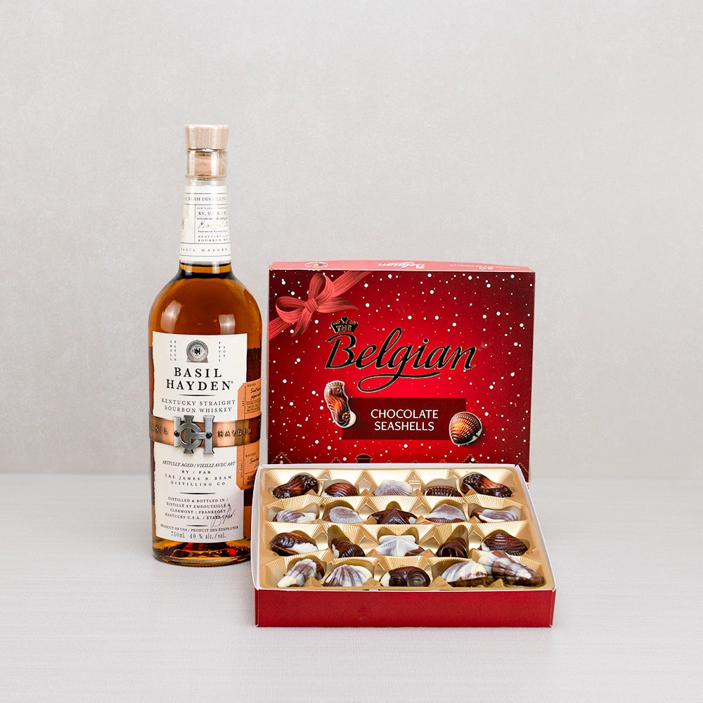 Whiskey & Chocolate Seashell Gift Set with Basil Hayden Kentucky bourbon and an open red box of Belgian chocolate seashells