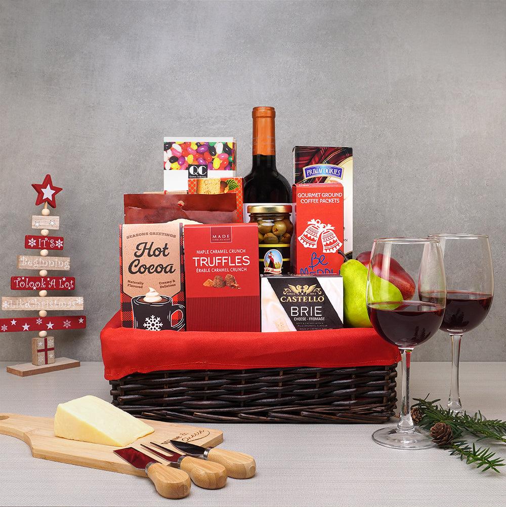 Christmas Magic Gift Basket with red wine, two wine glasses, Castello brie, maple caramel truffles and hot cocoa in wicker