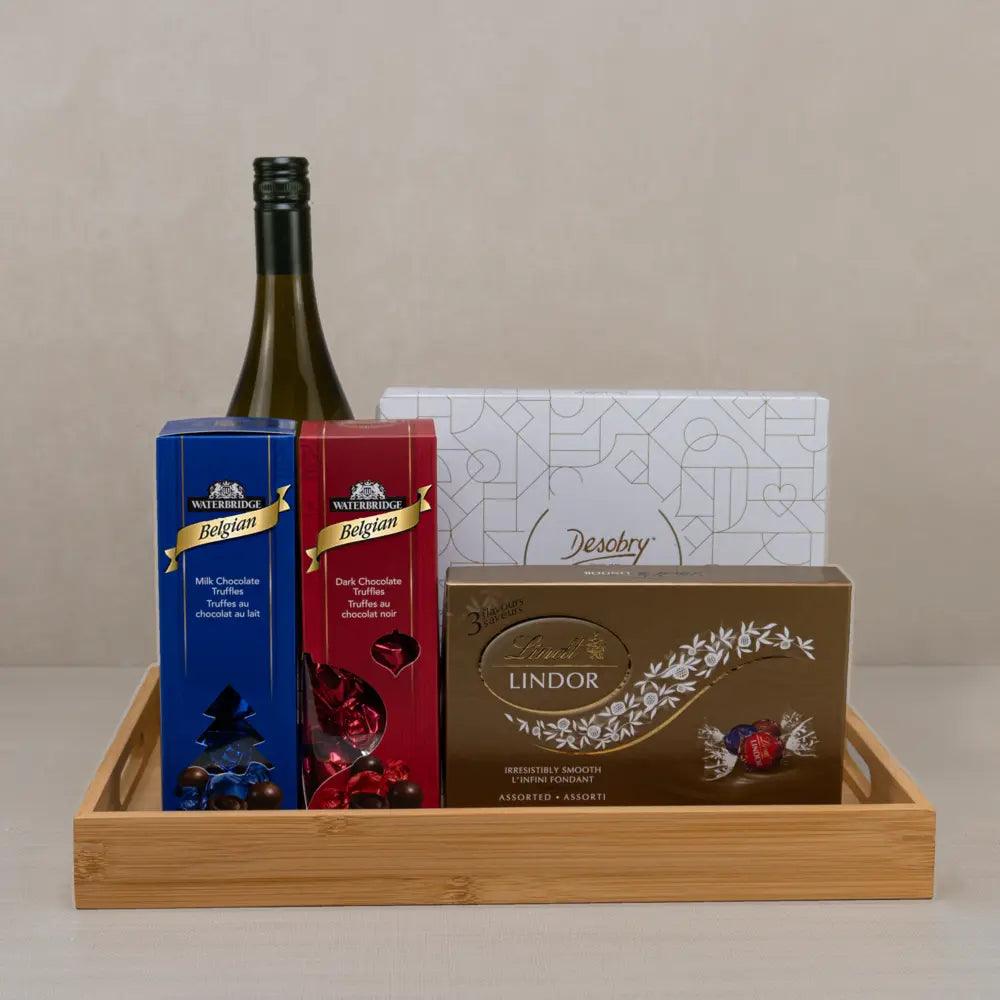 Luxurious Chocolate Indulgence Set with white wine, Lindt Lindor, Waterbridge truffles and Desobry biscuits on a bamboo tray