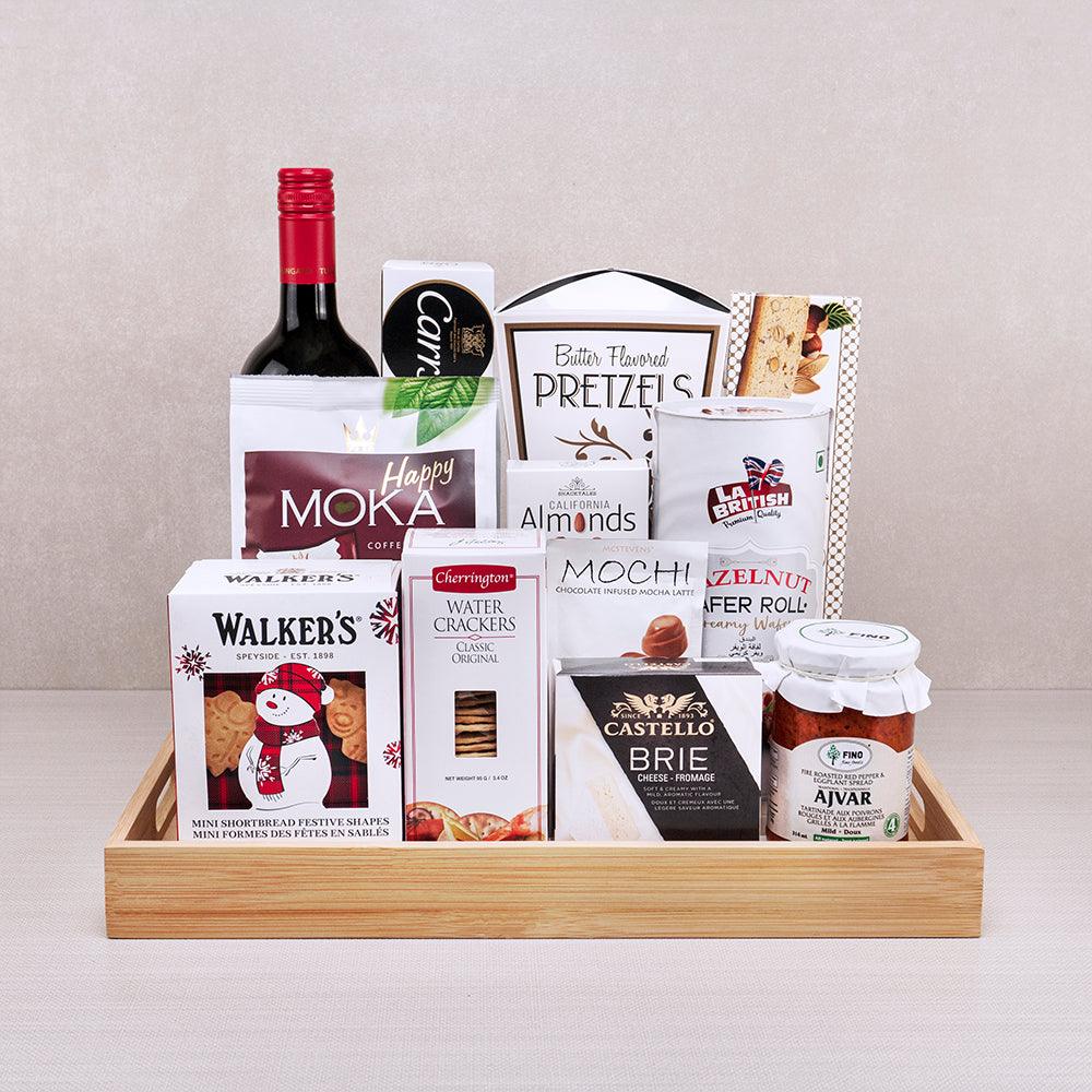 Satin Snow Gourmet Treasures gift tray with red wine, Walker's snowman shortbread, Castello brie, Ajvar and Happy Moka wafers